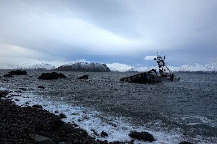 A hundred foot fishing vessel aground and awash near Dutch Harbor.
