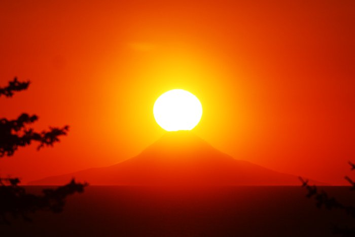 The sun sets atop Augustine Volcano.