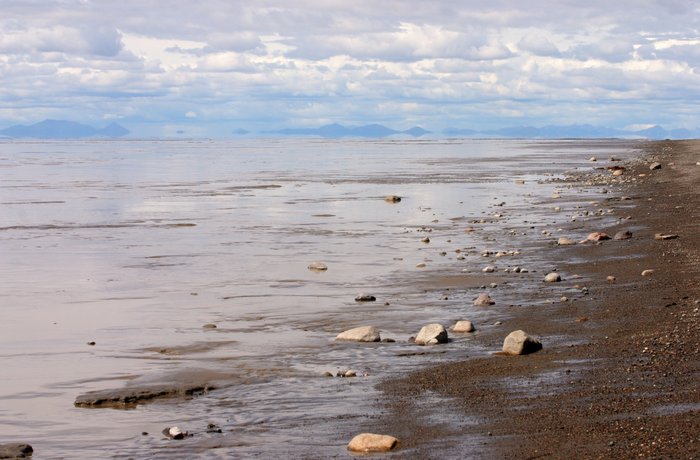 Edge of the beach and hills on the horizon, over the Bristol Bay mud flats.