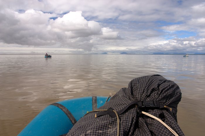 Alpacka rafts floating on calm glassy water on Nushagak Bay. 