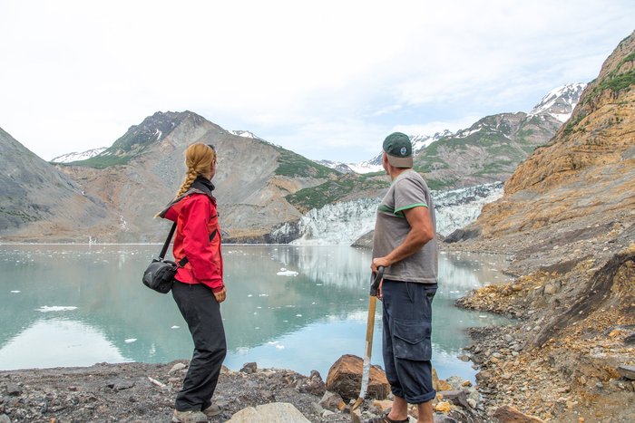 Marten Geertsema and Anja Dufresne, landslide experts, pause from their work to watch the Tyndall Glacier calve into Taan Fjord. Martin and Anja spent several days in the summer of 2016 investigating the landslide debris in Taan Fjord. 