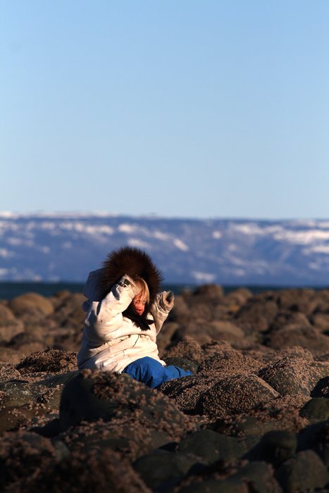 Nearly too dressed up to move, Katmai plops down on barnacle-covered rocks