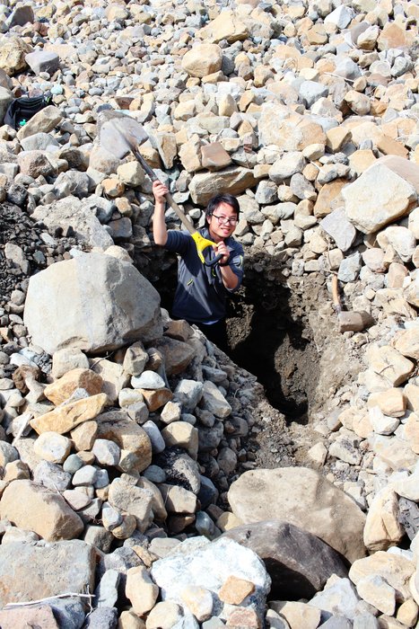 Hui Tang helps excavate a hole into sediment deposited by the 17 Oct 2015 tsunami in Taan Fjord.