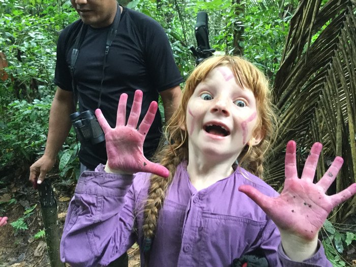 Lituya shows off her purple hands after dying them with the juice from the leaf of a bush that grows in the Amazon.