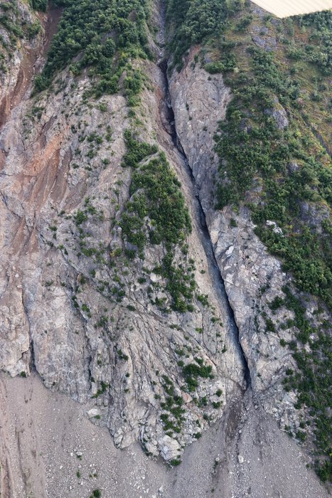 This open crack in the face of the slopes above Grewingk Lake might indicate rock weakened by numerous cracks (breccia). Such weak zones can be associated with slow shifting of rock that often precedes large landslides.
