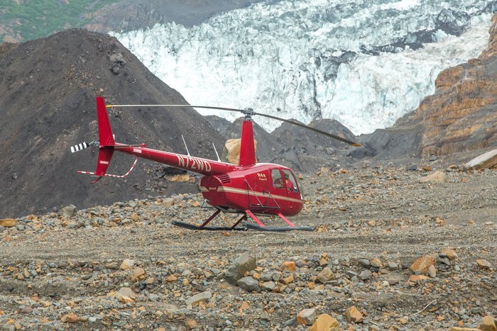 A Robinson 44 helicopter pauses on landslide debris. The helicopter was employed for a day to help scientists reach hard to access locations and provide an aerial perspective of the event.  