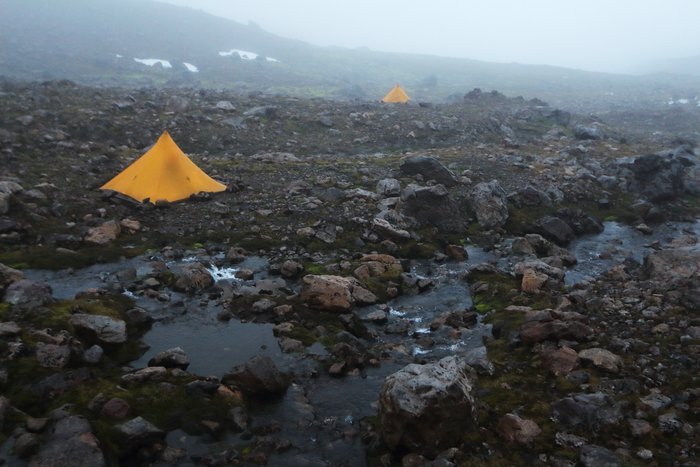 After a day of thick fog interspersed with brief views, we camped high in the mountains, anchoring our tents with piles of the largest boulders we could move.