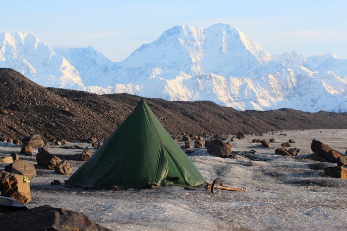 Far from the glacier edge, we camped on a patch of mud large enough to partially protect our bed from the icy chill of the glacier.  Blue ice all around lit the inside of the tent with a bizarre glow.