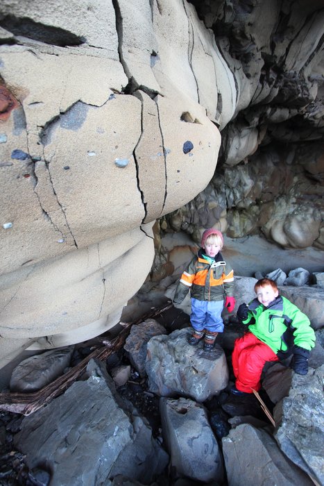 Katmai and Noah explore a sandstone cave.