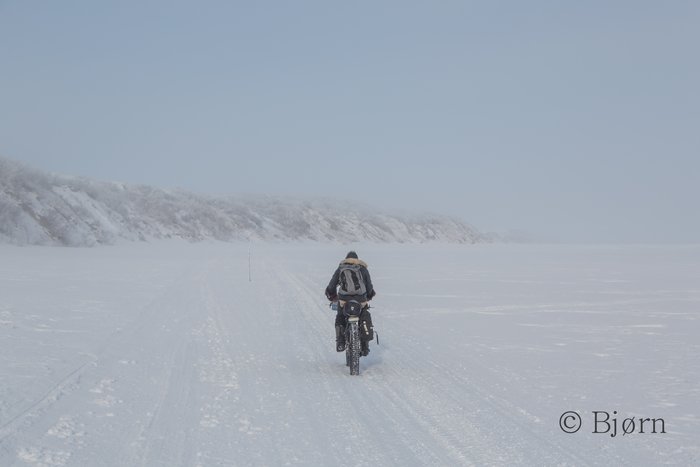 Kim rides on the sea ice offshore of the Baldwin Peninsula through morning ice fog.