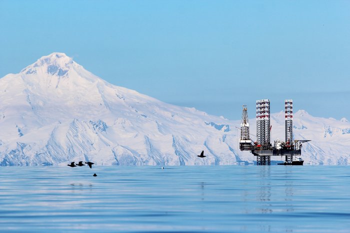 The Buccaneer jackup rig drills for oil and gas just north of Anchor Point, in Cook Inlet, Alaska.  Iliamna Volcano rises in the background.