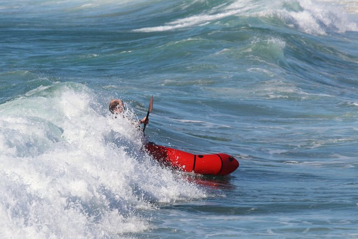 Running with a breaking wave in a packraft.