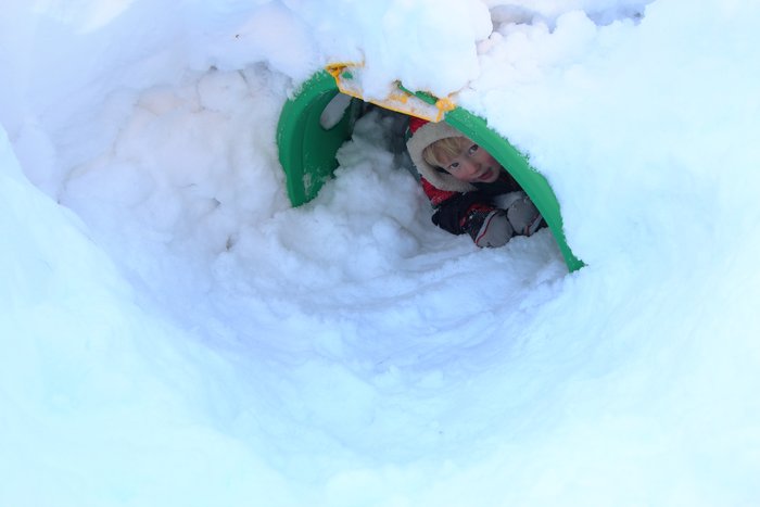A summer play structure becomes a winter fort beneath 5 feet of snow.