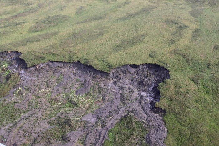 From the air, large areas of melting permafrost are visible on the Chukchi Sea coast.