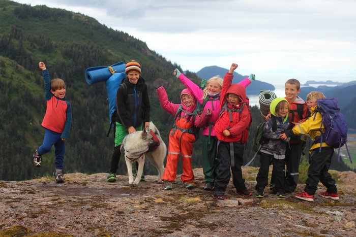 Kids pose on Lunch Mountain, celebrating their backpack trip on the new Tutka trail