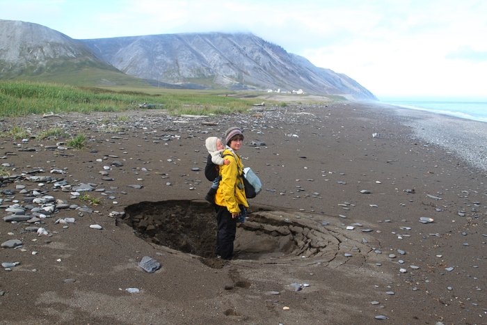 This sinkhole in a beach on the Chukchi sea is evidence that permafrost deep below is melting.