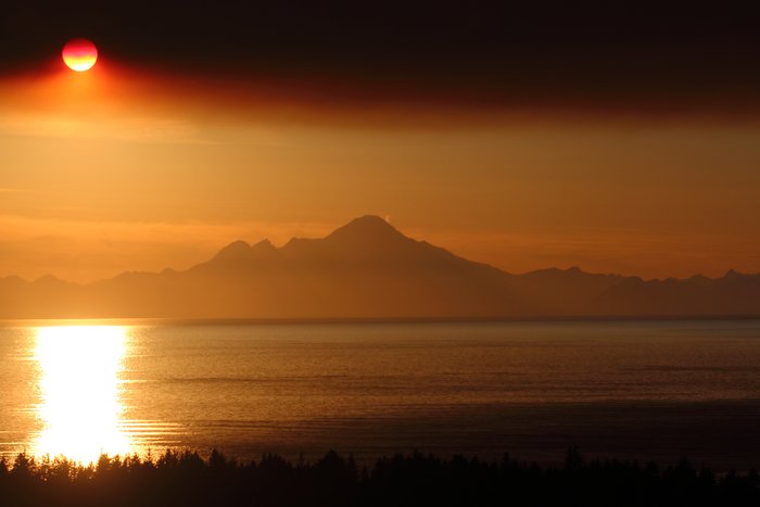 Smoke from the <a href="http://www.alaskadispatch.com/article/20140520/funny-river-wildfire-casts-shadow-over-kenai-peninsula">Funny River Wildfire</a> shadows the sun over Cook Inlet.