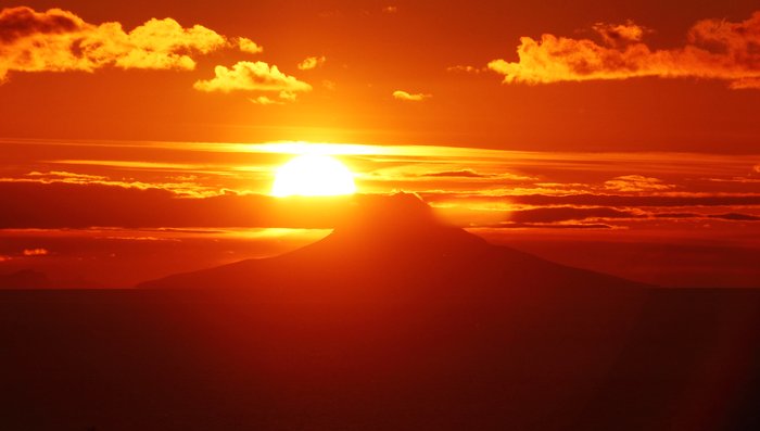 Once a year, the sun sets directly on Augustine's peak.