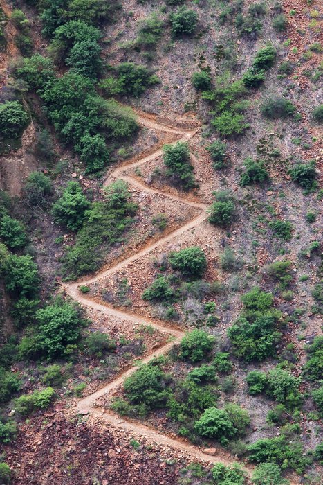 A large trail switchbacks up a steep trail on the way to the Choquequirao ruins in Peru.