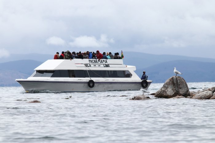 A tourist boat rounds the north end of Isla de la Luna in Lake Titicaca.