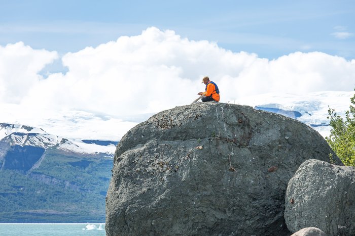 Andrew Mattox affixes a 'control point' atop of a glacial erratic in Icy Bay, Alaska. The control points, in this instance, were five gallon bucket lids with targets painted on them. The targets are useful for aerial surveys of Taan Fjord, which experienced a massive landslide and tsunami, in October 2015.  