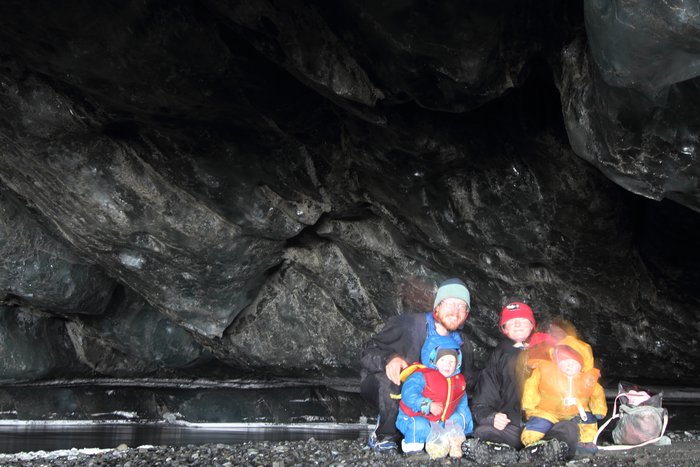 Family portrait in an ice cave, where we discovered a river that had recently shifted its route to disappear under the glacier near Malaspina Lake.